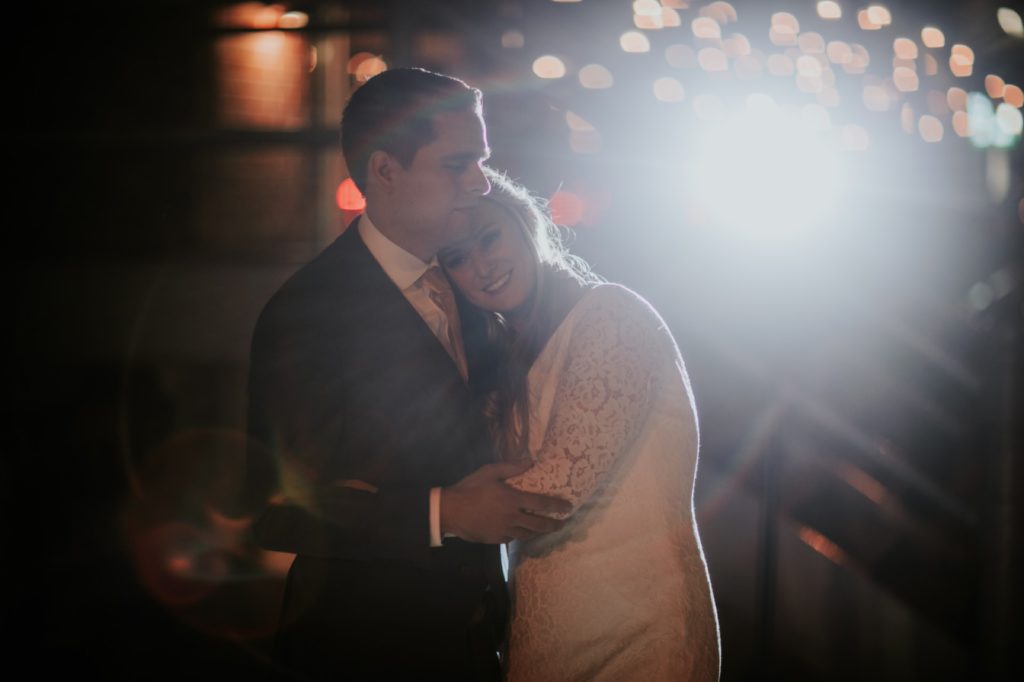 bride and groom hug at night on their VisionLoft Wedding day