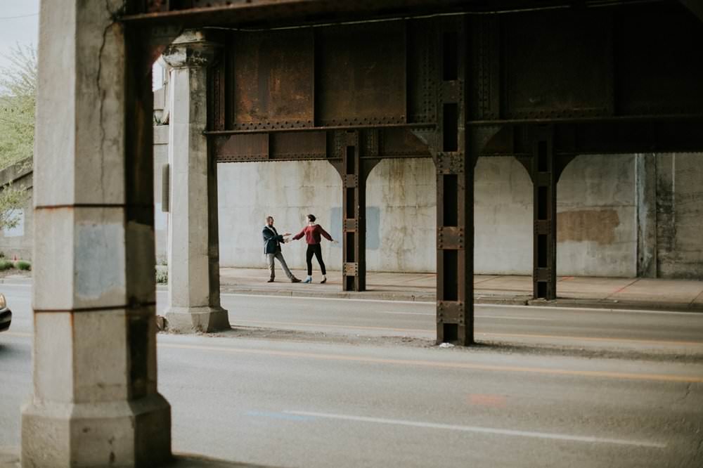 man and woman dance outside on street near the alexander hotel, one of the Best Indianapolis Engagement Photo Locations