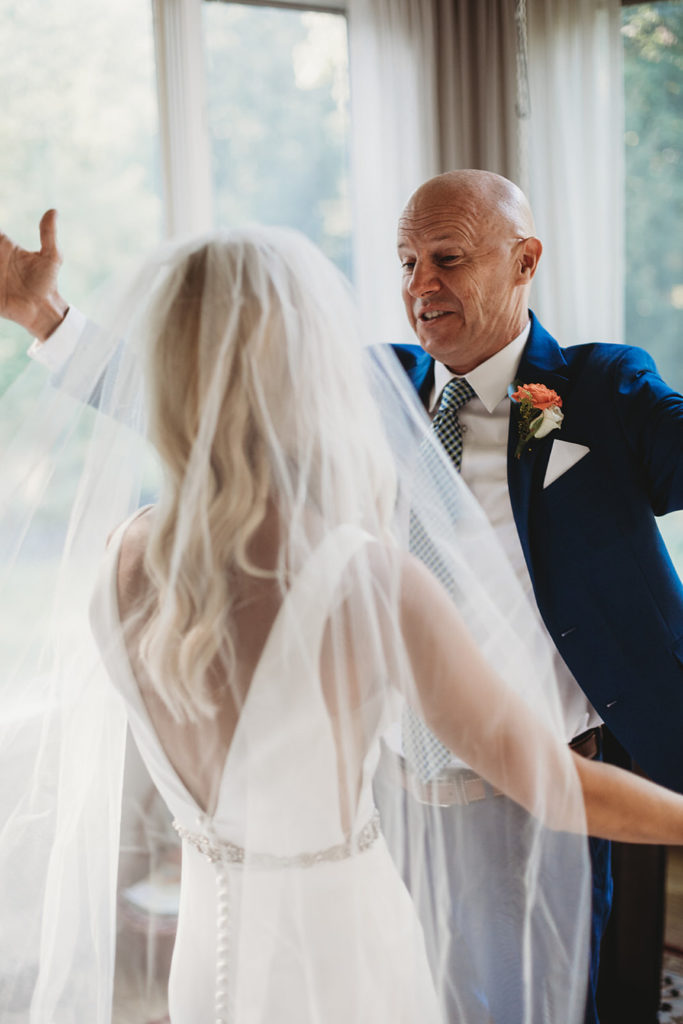 dad throws arms wide to hug daughter on her wedding day in carmel