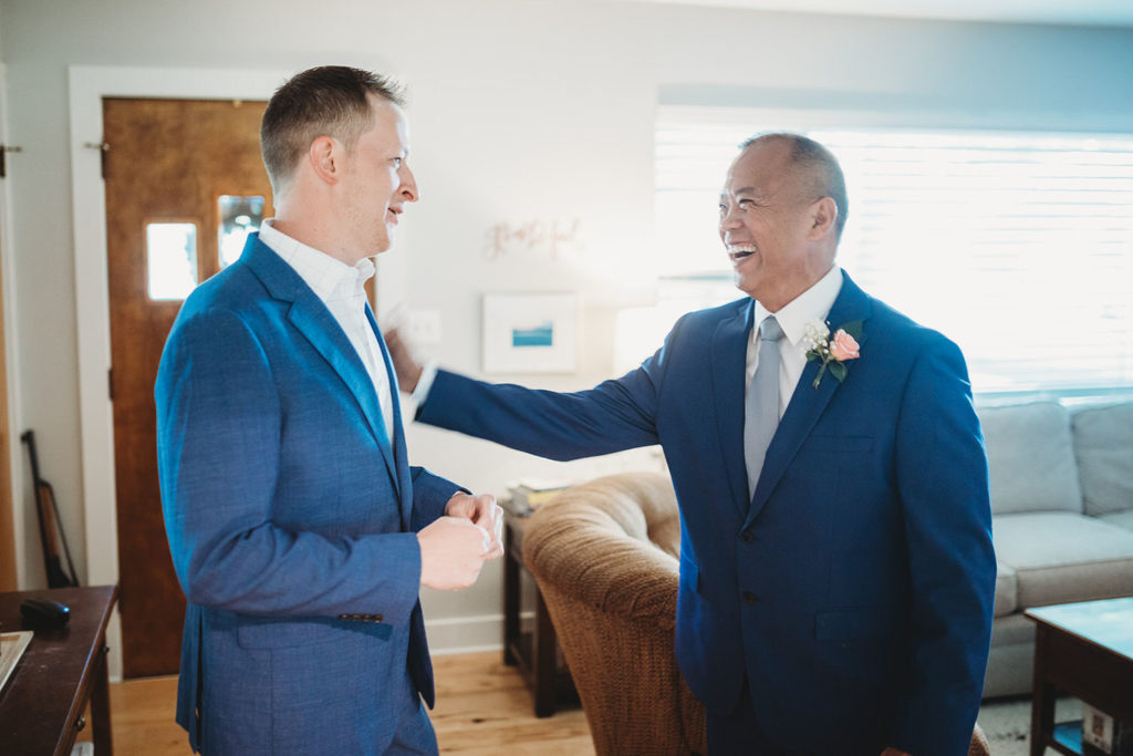 officiant pats groom on shoulder in carmel indiana
