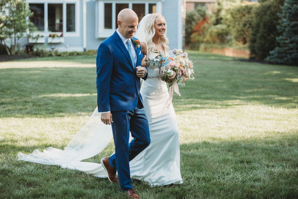 blonde bride walked to ceremony in backyard by her father in carmel indiana
