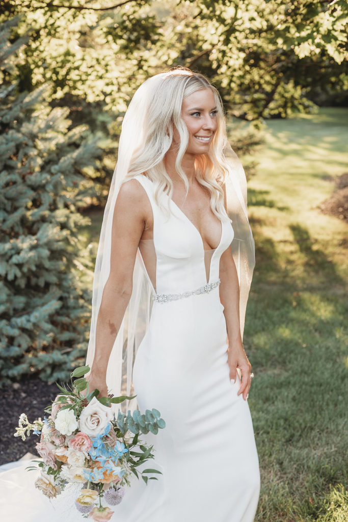 blonde bride smiling and holding bouquet during her indianapolis elopement