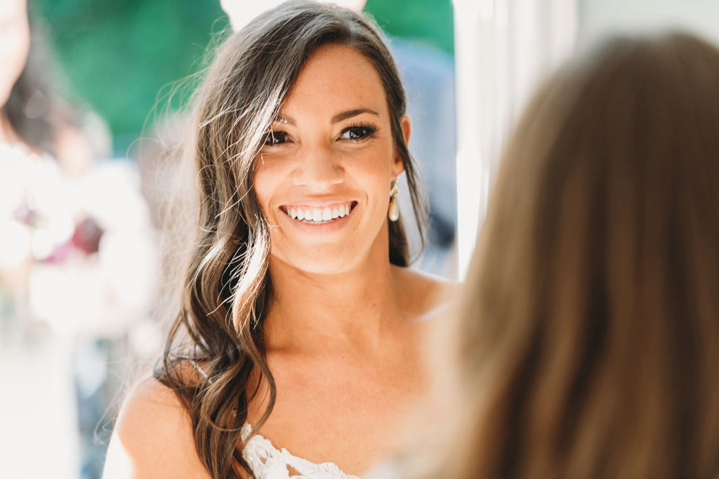 bride smiles and walks into crowd of people