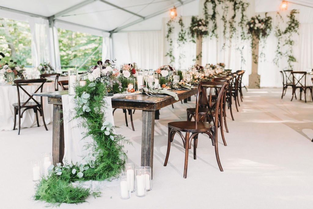 floral arrangement winds and hangs off table at a Carmel Backyard Wedding