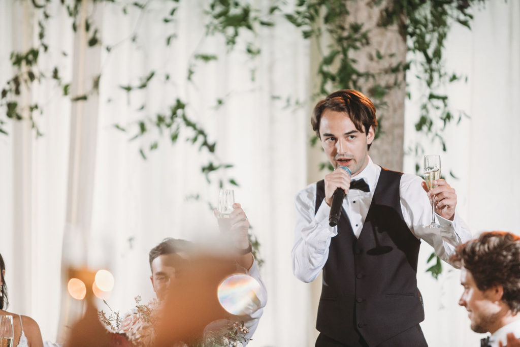 best man holding microphone and giving a toast