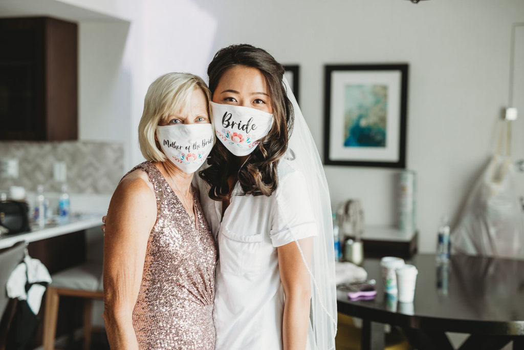 bride and mother of bride wearing Coronavirus masks while getting ready for an Indiana Roof Ballroom wedding