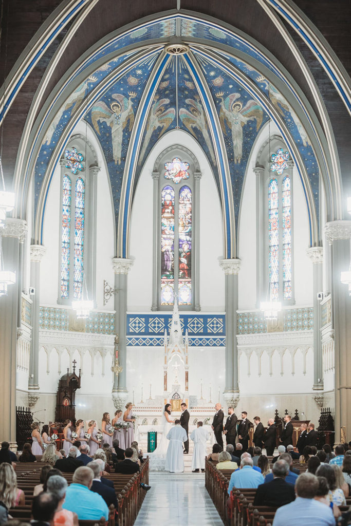 Wide shot of the altar at St. John the Evangelist Catholic Church during a wedding ceremony