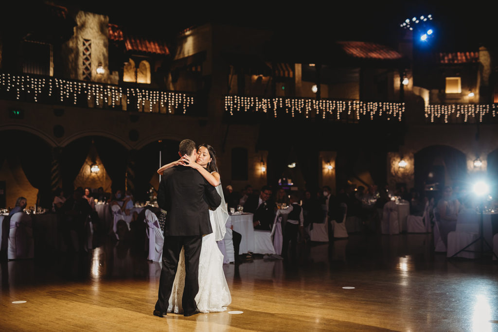 bride and groom share first dance in front of guests at their Indiana Roof Ballroom wedding