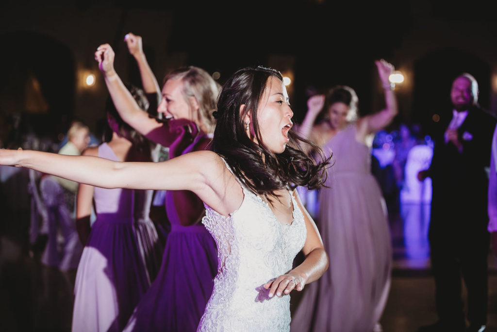 bride dances exuberantly at her Indiana Roof Ballroom wedding 