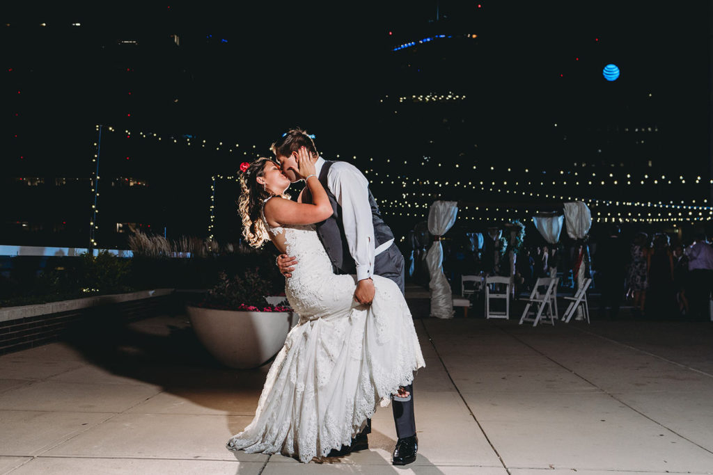 bride and groom dance in moody night shot at a Regions Tower Wedding Celebration