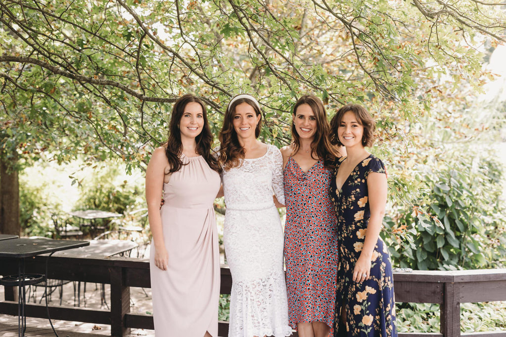 bride poses for photo with sister and friends at traders point creamery