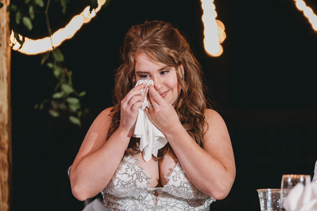 bride cries into handkerchief at a 3 Fat Labs wedding