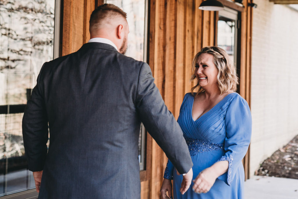 groom's mom in blue dress sees him for first time on wedding day at a 3 Fat Labs wedding