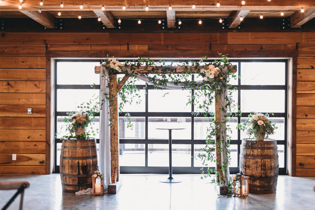 wooden structure with floral hanging off of it at a 3 Fat Labs wedding