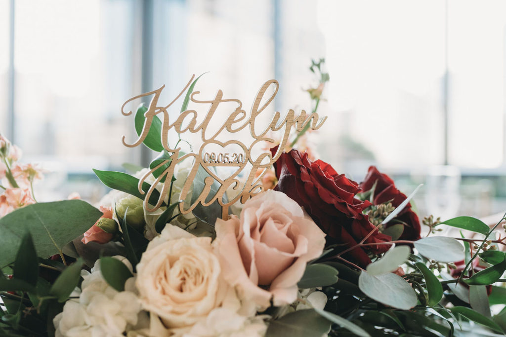 close up of sign on top of flowers at a Regions Tower Wedding Celebration