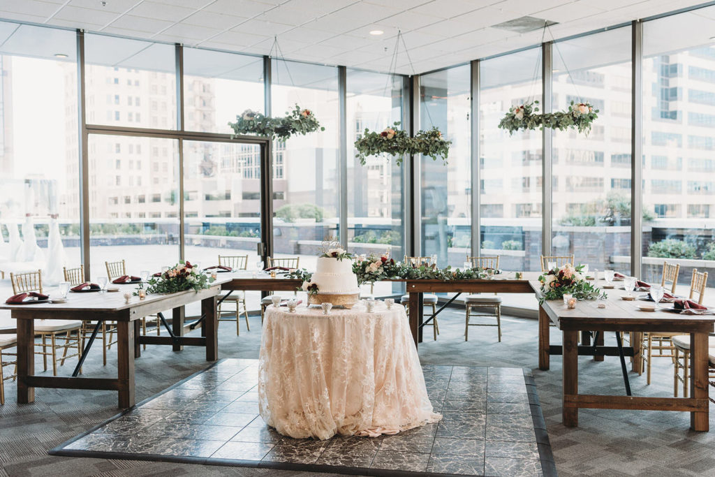 cake and hanging floral at a Regions Tower Wedding Celebration
