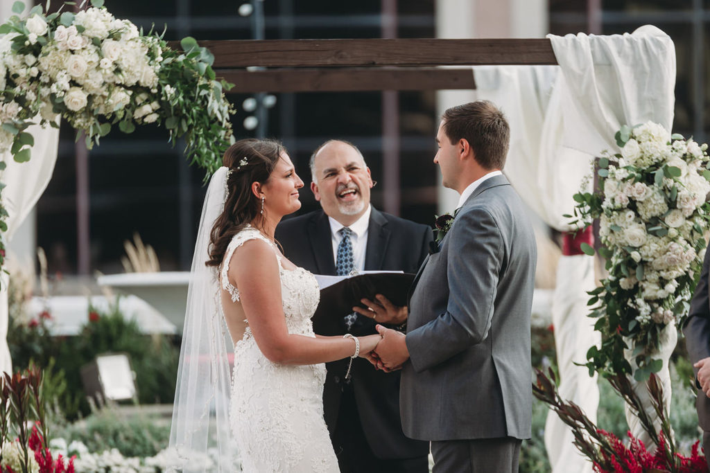 bride and groom being married by officiant at a Regions Tower Wedding Celebration