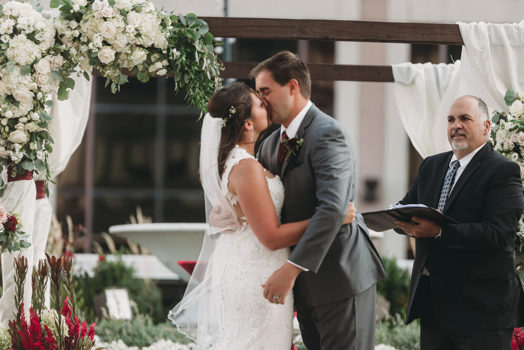 bride and groom kiss for the first time on the wedding day at a Regions Tower Wedding Celebration
