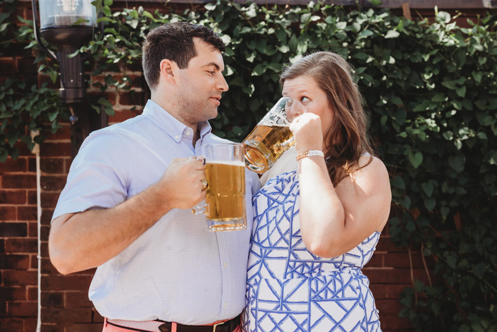 man and woman hold each other close while drinking beer during their Rathskeller engagement session