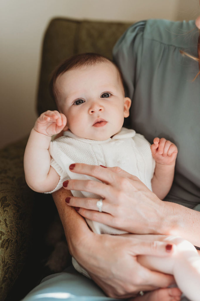 mom's hands holding baby girl in this lifestyle family photography session