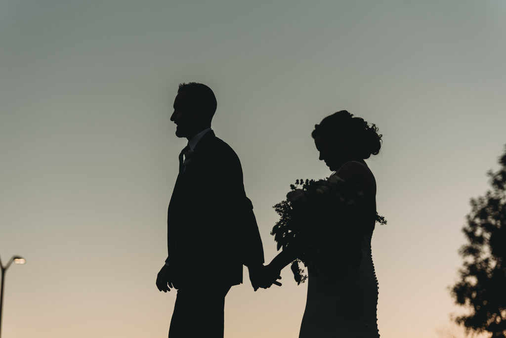 silhouette of bride and groom at sunset at a woolery mill wedding