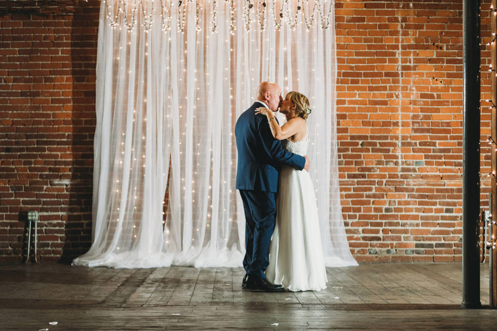 bride and groom kiss at end of first dance at mill top wedding noblesville