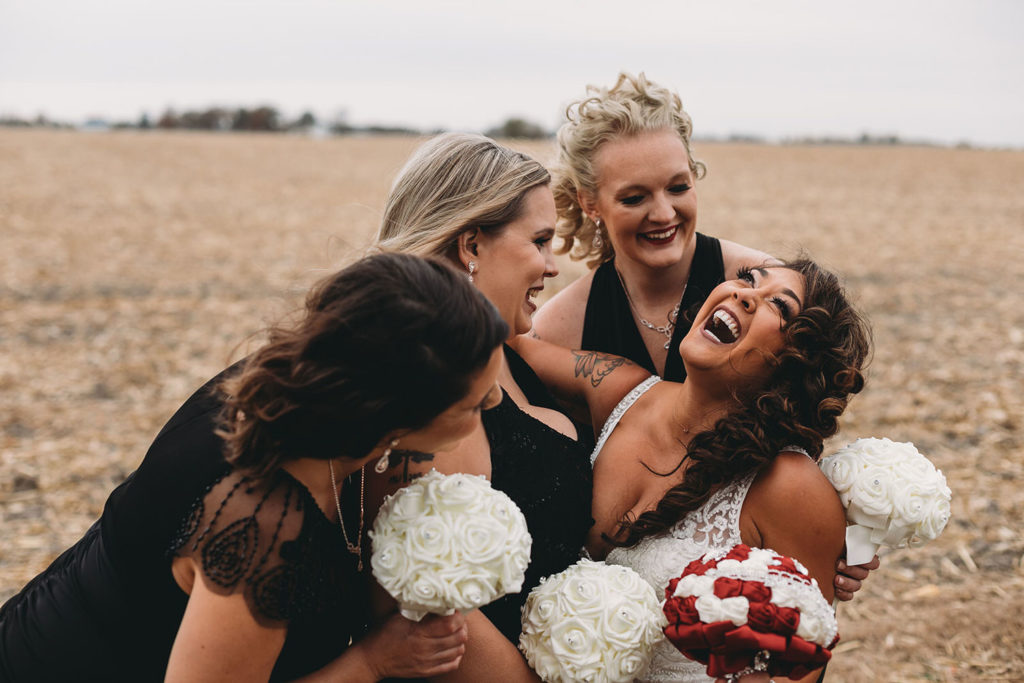 bride laughing with bridesmaids at a Franklin Barn Wedding