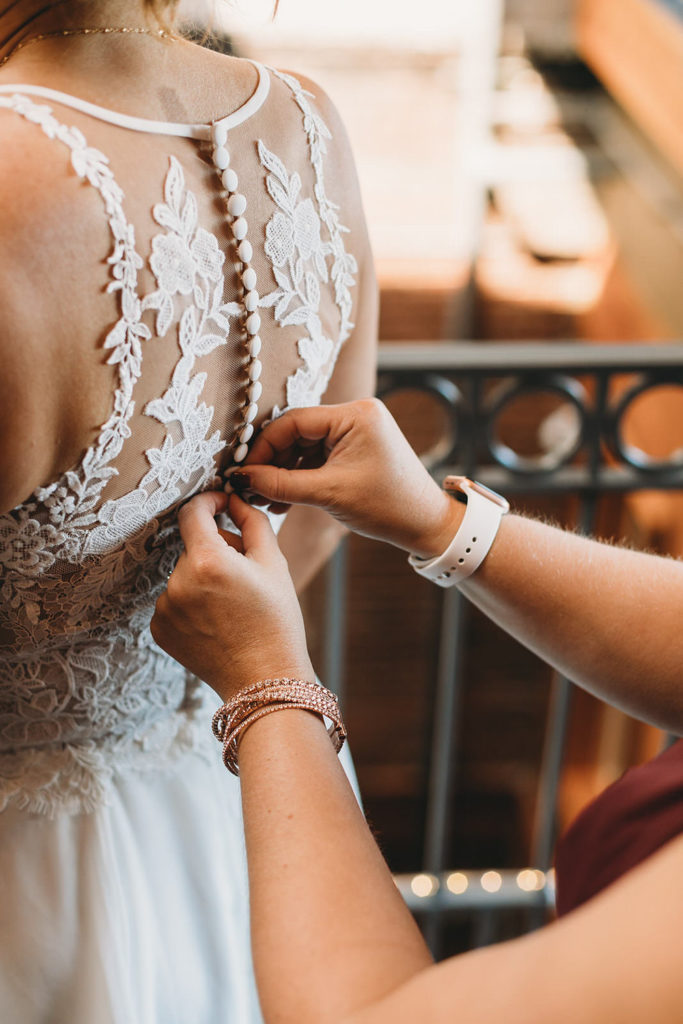 bride have dress buttoned up at mill top wedding noblesville