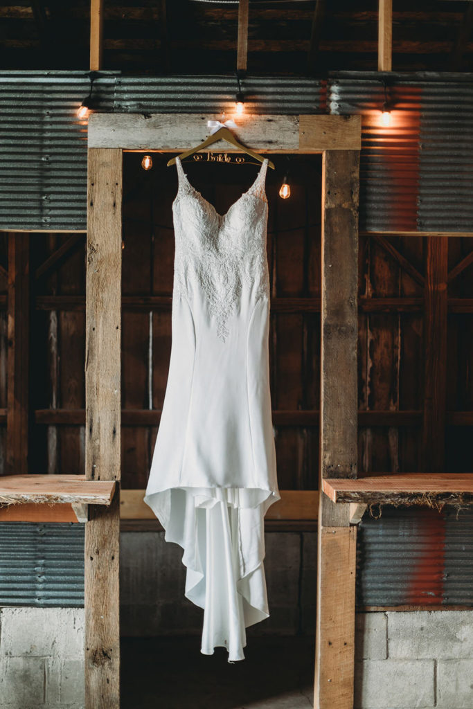 wedding dress hanging in a metal and wood door frame at a Franklin Barn Wedding