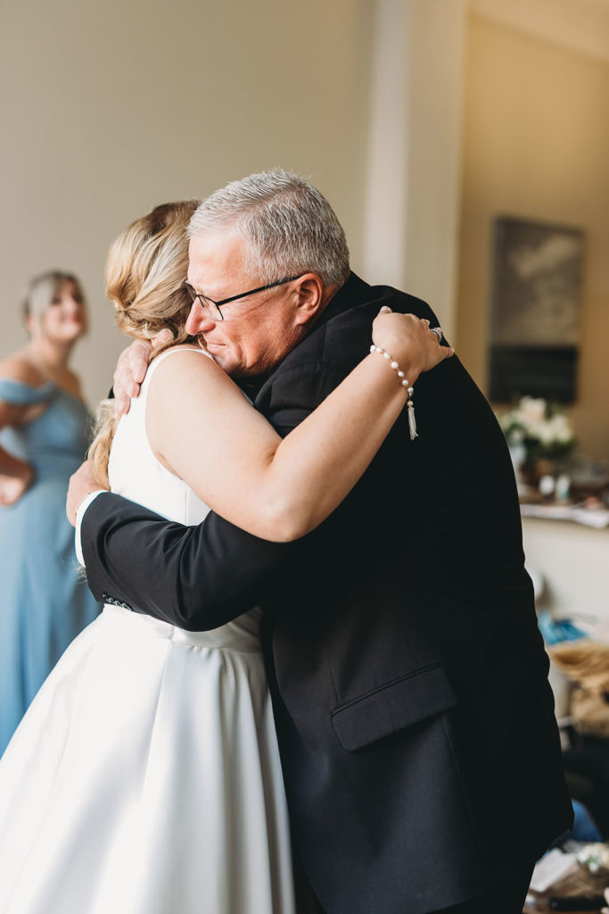 bride hugs father during first look with him before her 1899 wedding