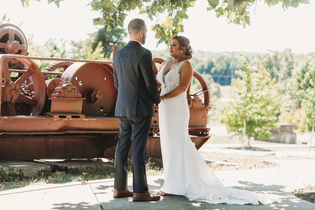 bride and groom hold hands and look deep into each other's eyes at a woolery mill wedding
