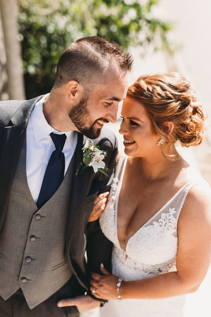 bride and groom look endearingly into each other's eyes at a woolery mill wedding