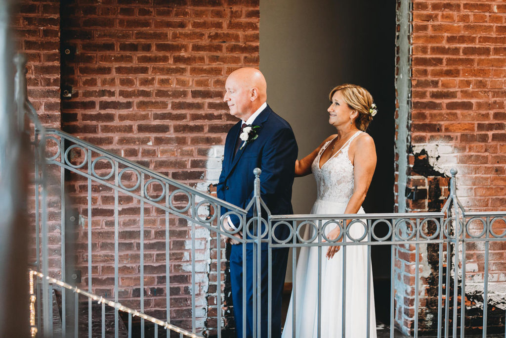 bride and groom first look on balcony at mill top wedding noblesville