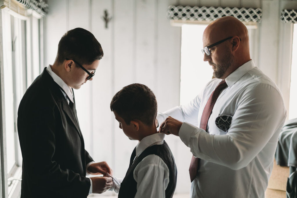 groom helps his new sons get ready at a Franklin Barn Wedding