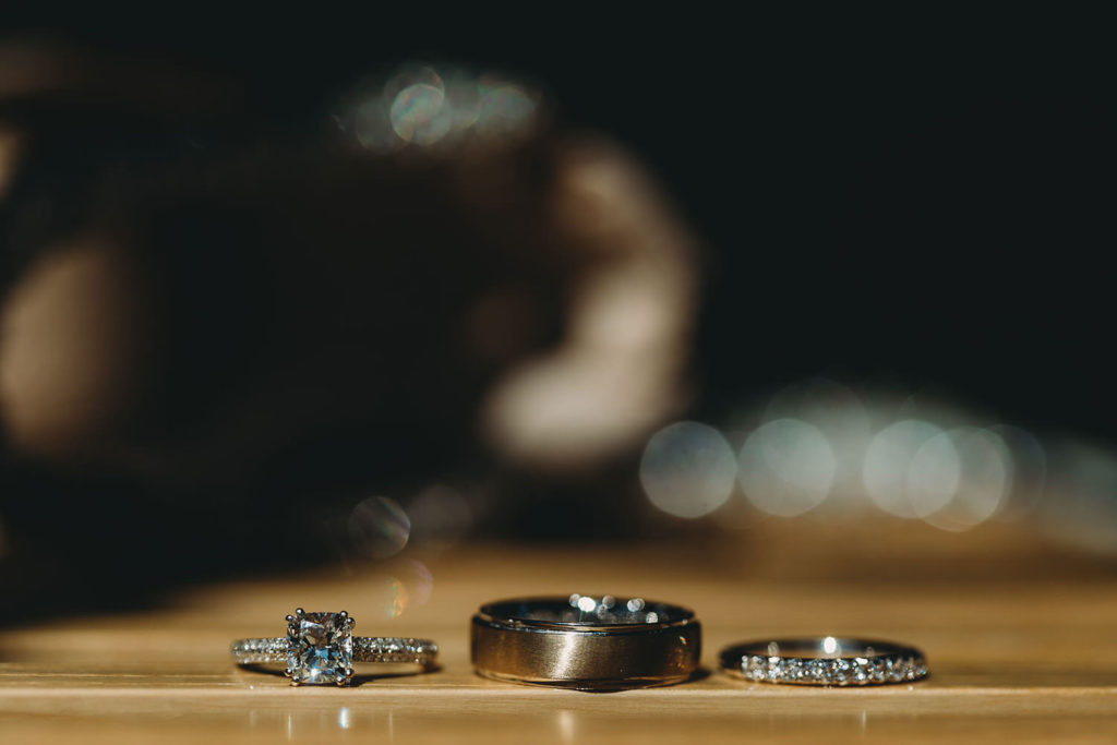wedding rings and engagement ring with bokeh at a woolery mill wedding