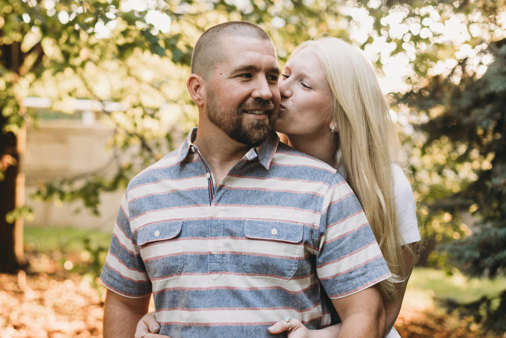 woman kisses man during during Lincoln Park engagement photos