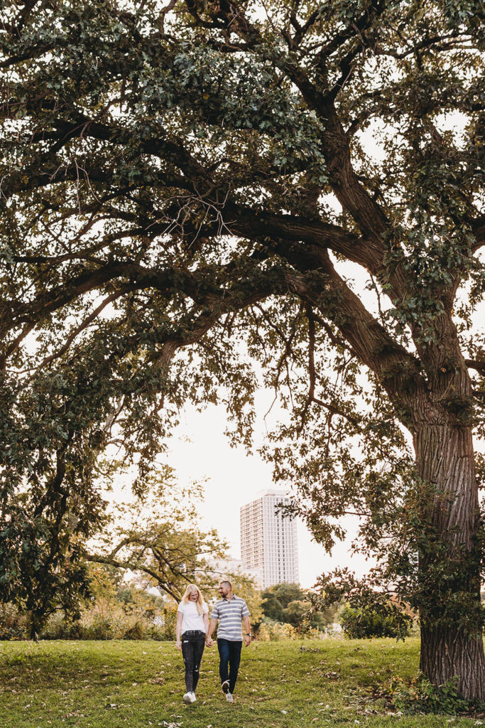 couple under branches of large tree during Lincoln Park engagement photos