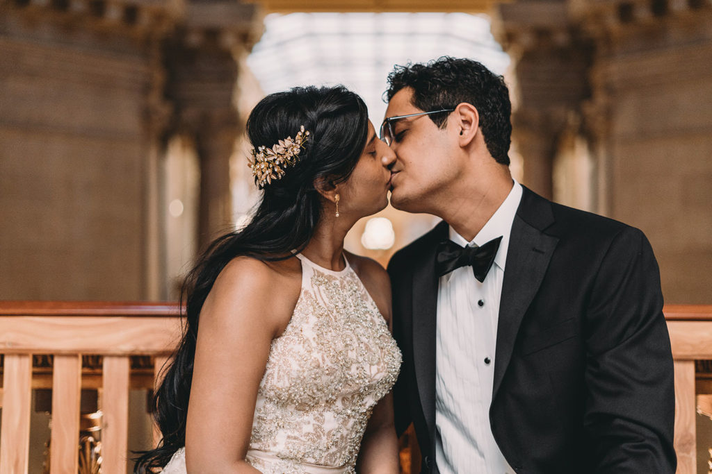 bride and groom kiss on bench at their Indiana Statehouse Elopement