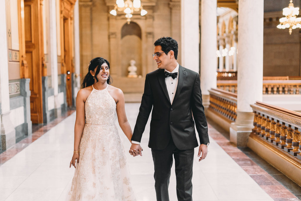 bride and groom walking hand in hand at their Indiana Statehouse Elopement