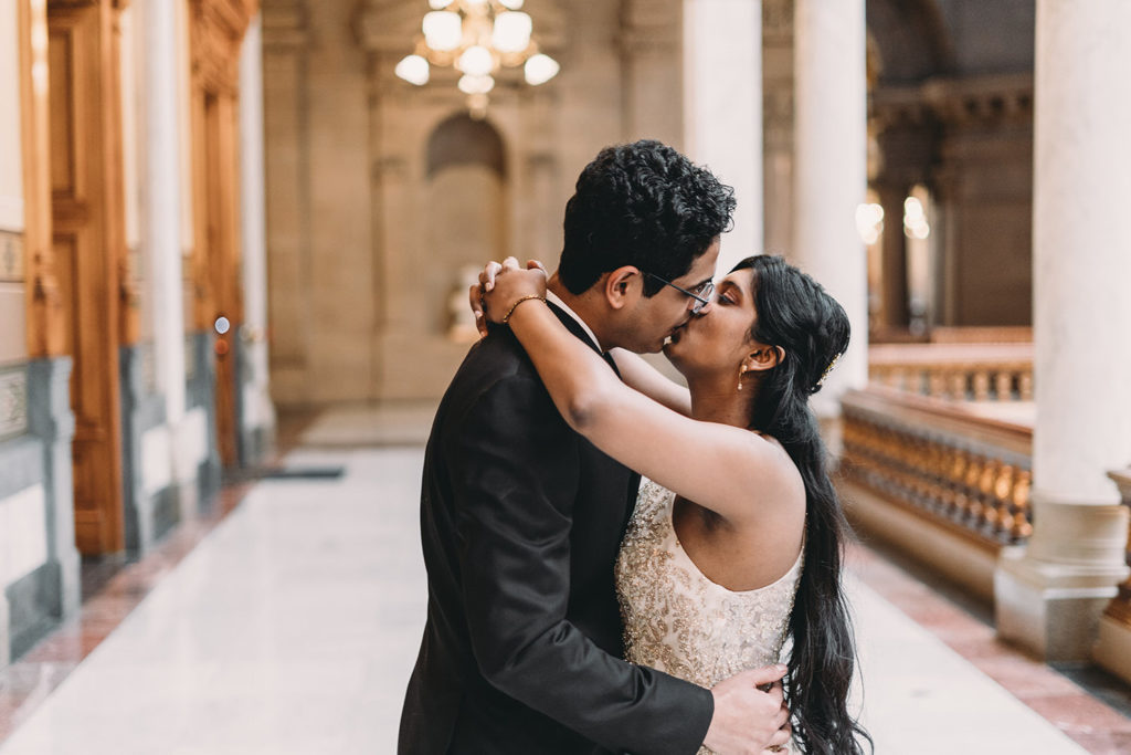 bride and groom kiss in hall at their Indiana Statehouse Elopement