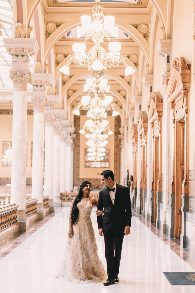 bride and groom walk down hall at their Indiana Statehouse Elopement