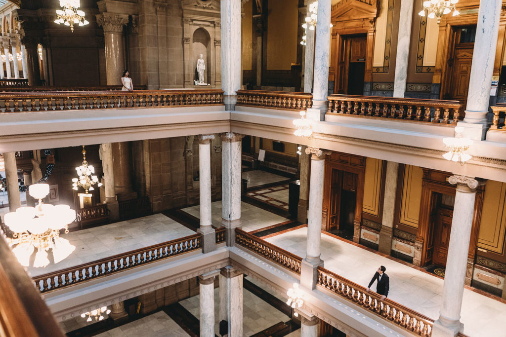 bride and groom on separate floors during their Indiana Statehouse Elopement 