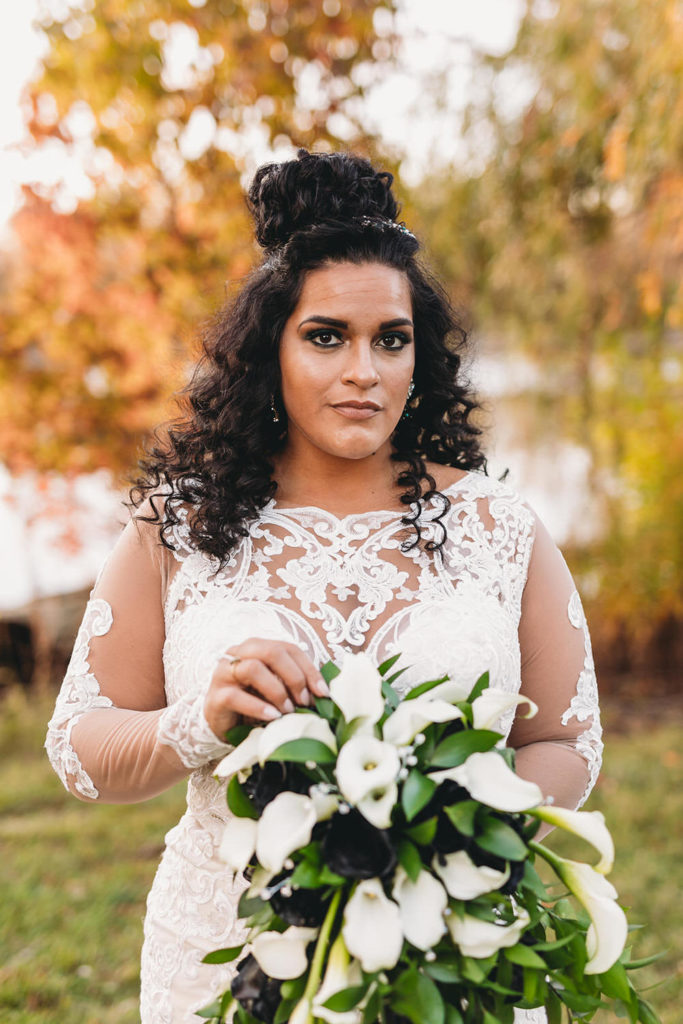 bride in fall foliage before a ceruti wedding