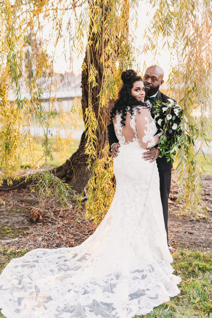 bride looking back in front of weeping willow tree before her ceruti wedding