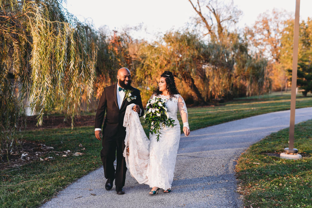 bride and groom walk down pathway at IPFW before their ceruti wedding
