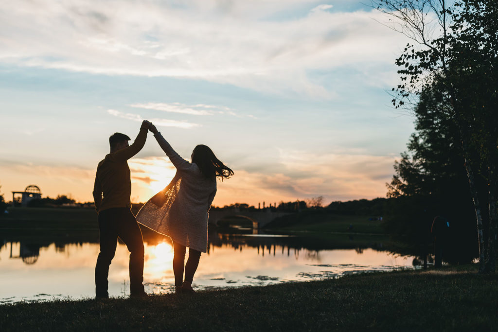 couple silhouetted and dancing at sunset during their coxhall gardens engagement session