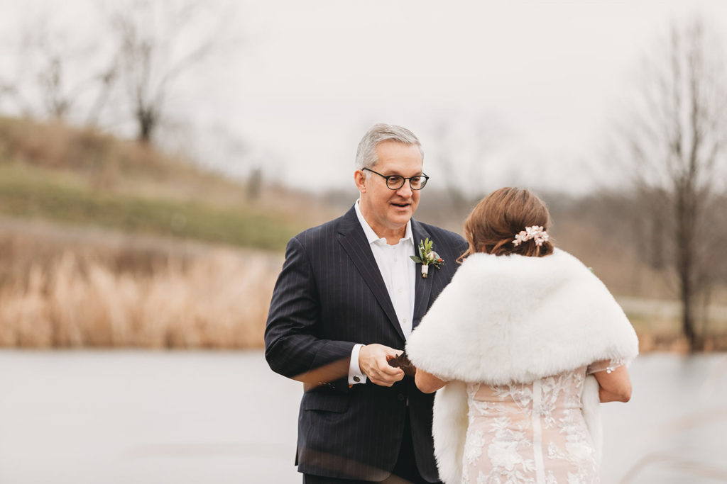 first look with groom in glasses and bride at traders point creamery elopement