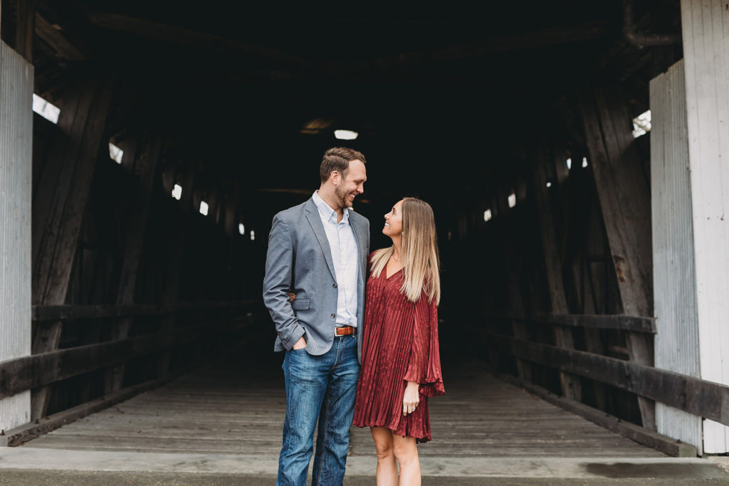 elegant young couple on covered bridge captured by their Noblesville Photographer