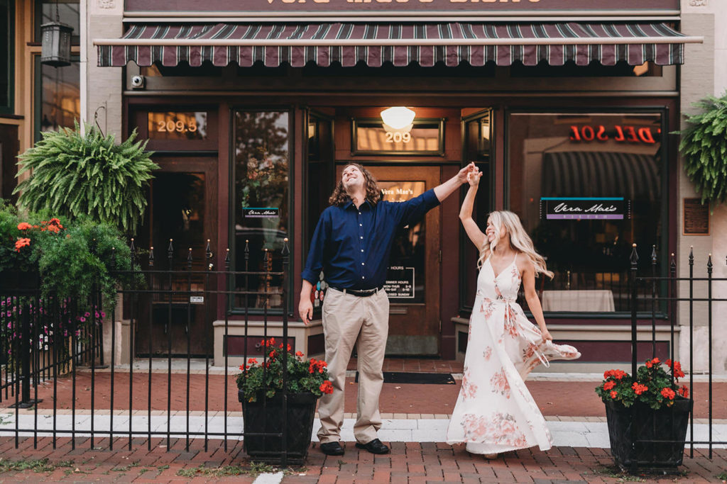 man and woman dance during Downtown Muncie Engagement session