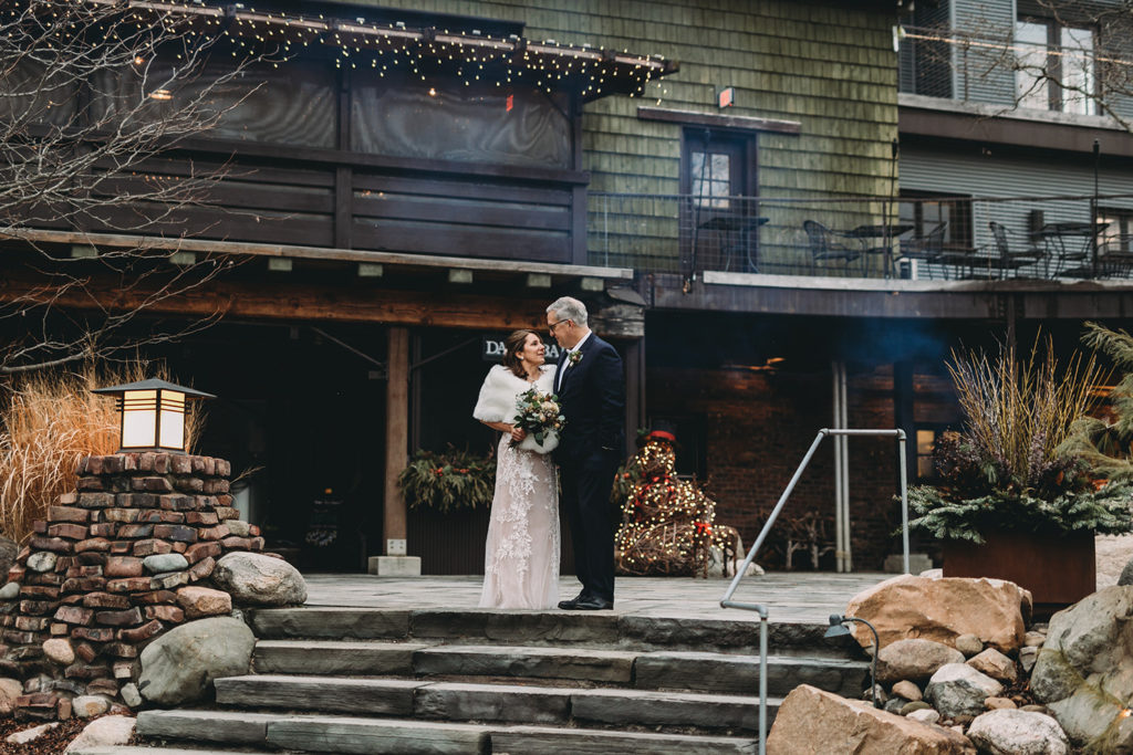 bride and groom stand on steps during their traders point creamery elopement